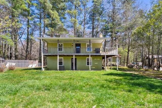 back of property featuring a yard and central air condition unit