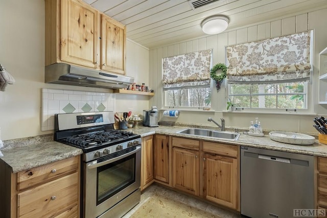 kitchen featuring light stone countertops, stainless steel appliances, tasteful backsplash, and sink