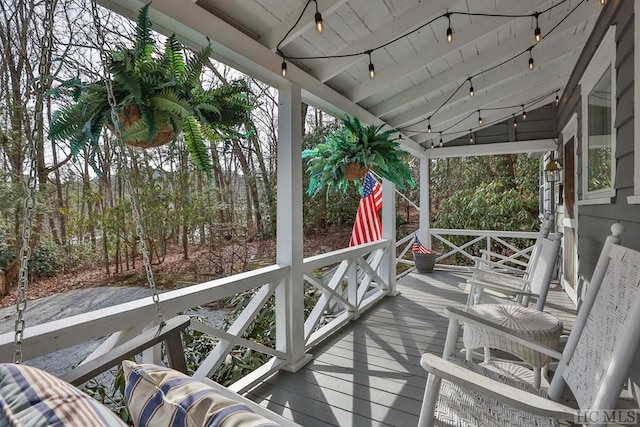 wooden terrace with a porch