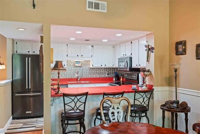 369 Meadow Way Unit 1713, Sapphire, NC 28774 - kitchen featuring high end refrigerator, stove, backsplash, white cabinets, and recessed lighting