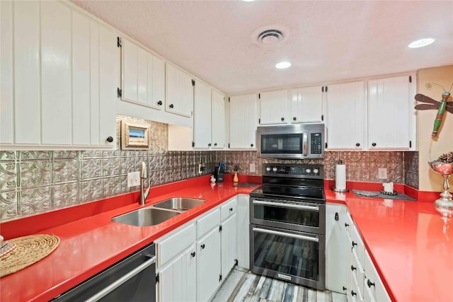 369 Meadow Way Unit 1713, Sapphire, NC 28774 - kitchen featuring stainless steel appliances, backsplash, and white cabinets
