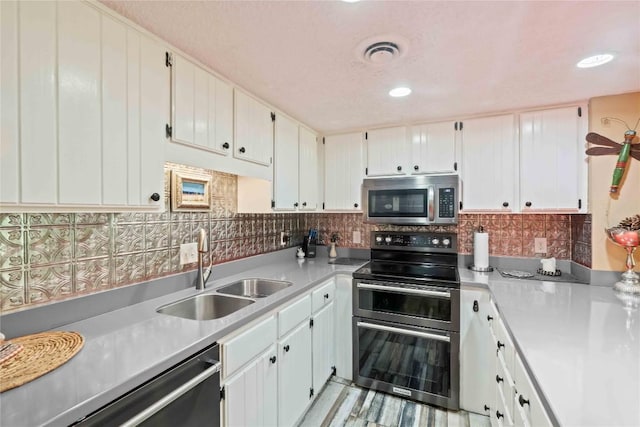 369 Meadow Way Unit 1713, Sapphire, NC 28774 - kitchen with stainless steel appliances, light countertops, backsplash, white cabinets, and recessed lighting