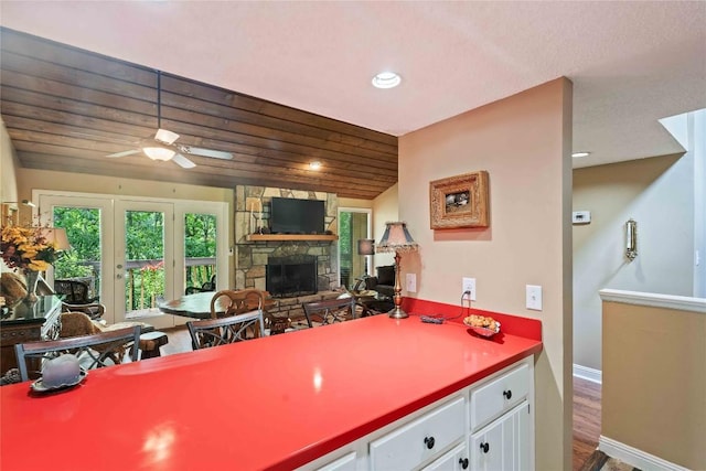 369 Meadow Way Unit 1713, Sapphire, NC 28774 - kitchen featuring a fireplace, wood finished floors, a ceiling fan, white cabinetry, and recessed lighting