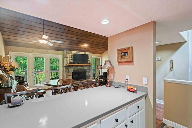 369 Meadow Way Unit 1713, Sapphire, NC 28774 - kitchen featuring white cabinets, a fireplace, wood finished floors, ceiling fan, and recessed lighting