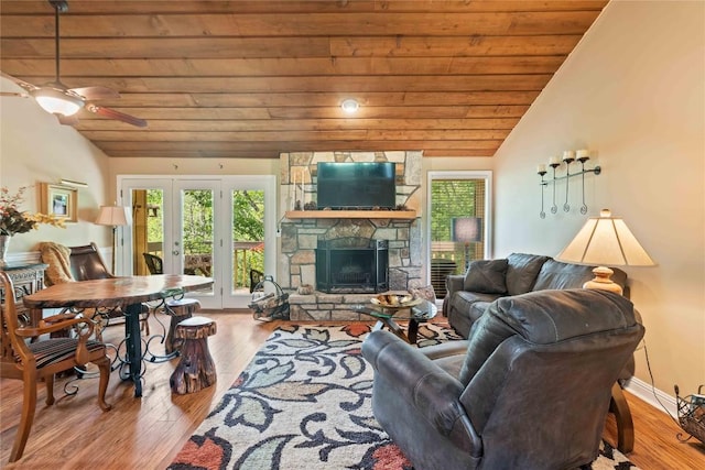369 Meadow Way Unit 1713, Sapphire, NC 28774 - living room featuring vaulted ceiling, wooden ceiling, plenty of natural light, wood finished floors, and a stone fireplace
