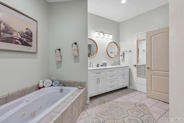 bathroom with tile patterned floors, tiled bath, and vanity