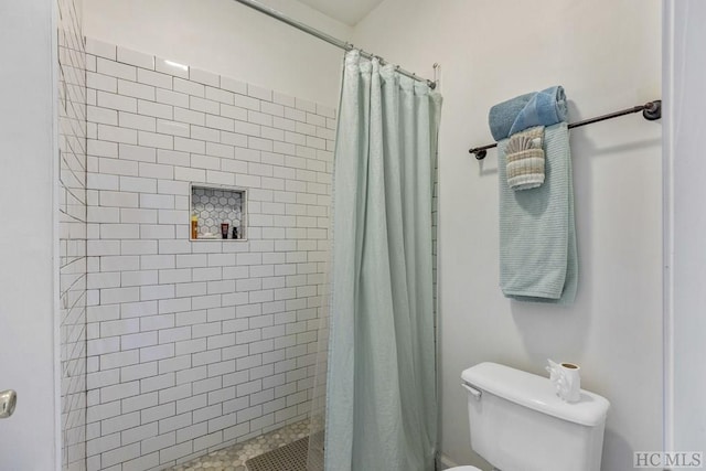 bathroom with walk in shower and toilet