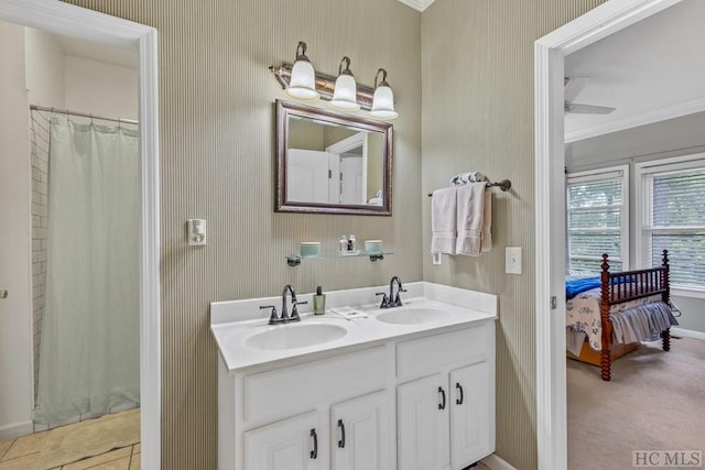 bathroom with ornamental molding, curtained shower, vanity, and ceiling fan