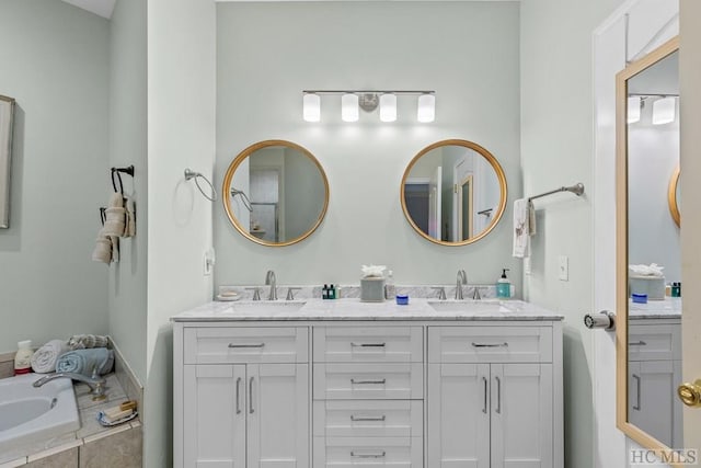 bathroom featuring vanity and tiled tub