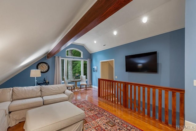 living room featuring lofted ceiling with beams and light wood-type flooring