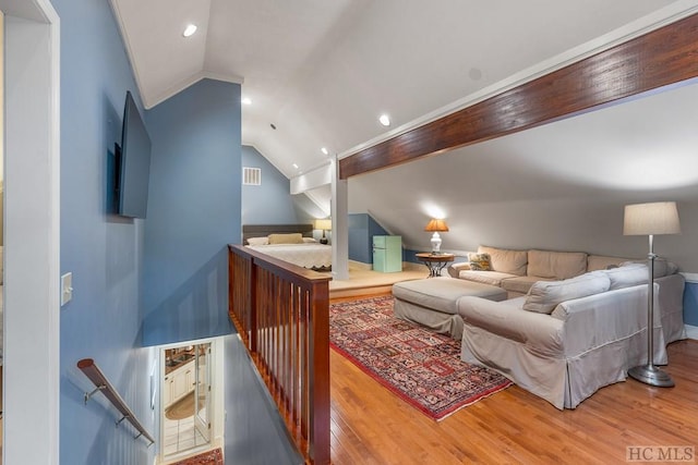 interior space with hardwood / wood-style flooring, ornamental molding, and lofted ceiling