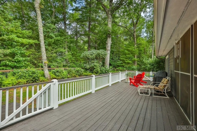 wooden terrace with a grill