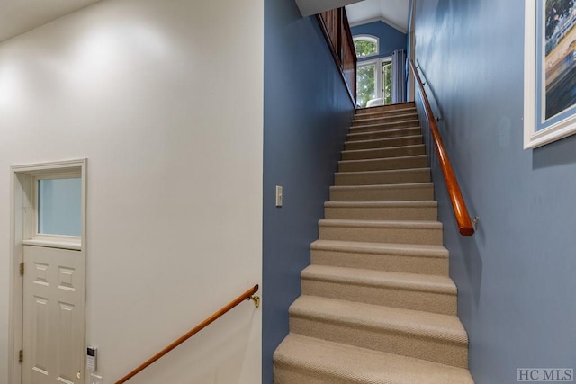 stairway with vaulted ceiling