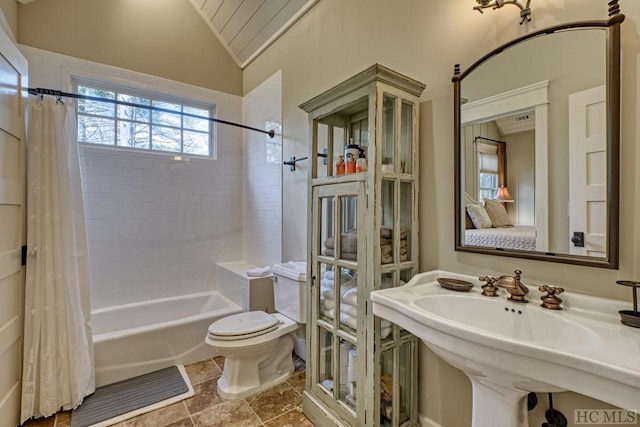 full bathroom featuring toilet, sink, vaulted ceiling, and shower / tub combo