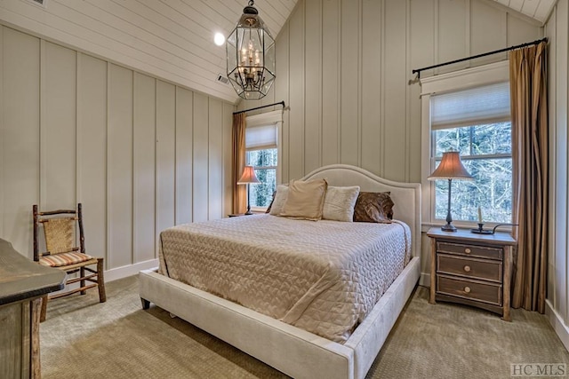 bedroom with an inviting chandelier, light colored carpet, and lofted ceiling