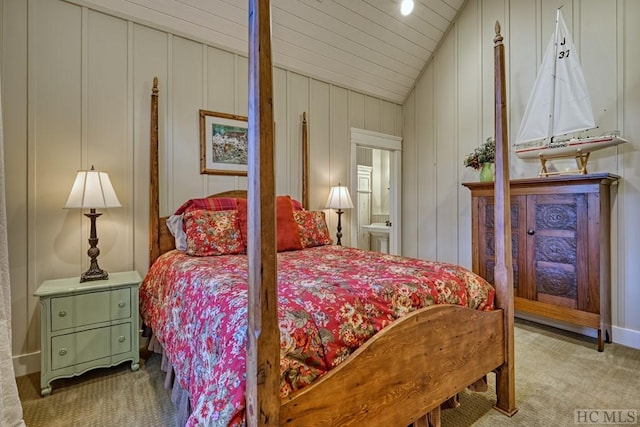 carpeted bedroom with lofted ceiling