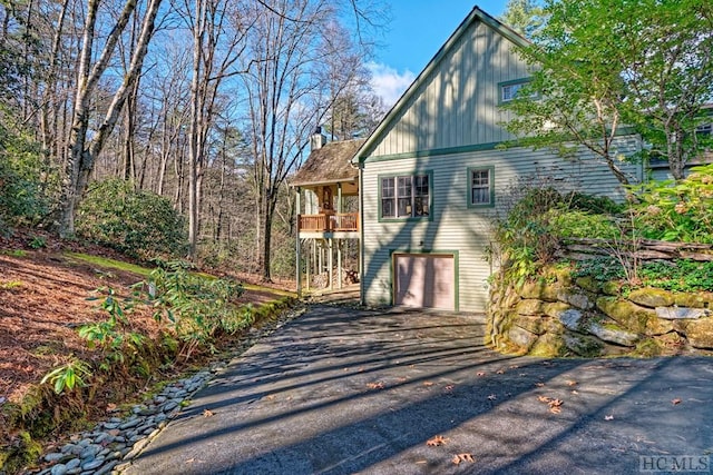 view of home's exterior featuring a garage and a balcony