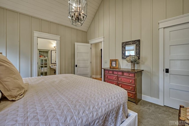 carpeted bedroom featuring lofted ceiling and an inviting chandelier