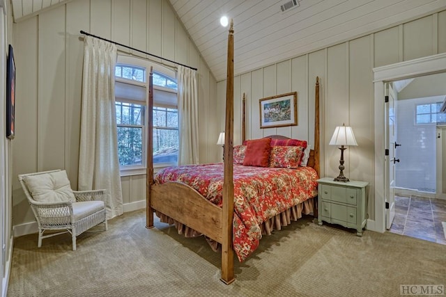 bedroom featuring light colored carpet, connected bathroom, and vaulted ceiling