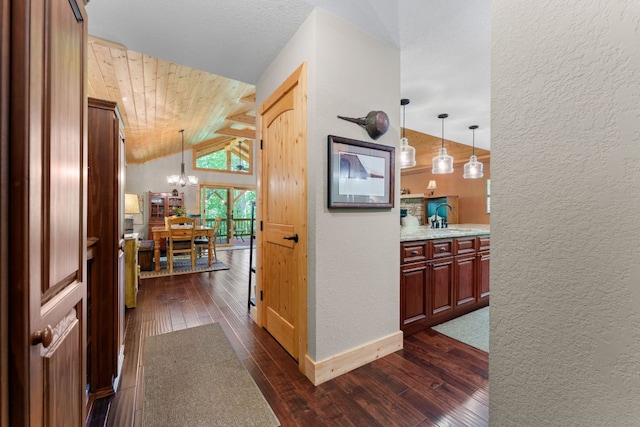 293 Gem Creek Rd, Cullowhee, NC 28723 - hall featuring a textured wall, a chandelier, dark wood-style flooring, vaulted ceiling, and wood ceiling