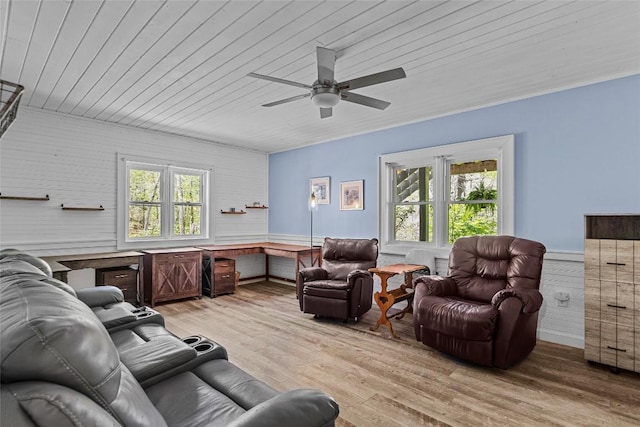 living room with a healthy amount of sunlight, light hardwood / wood-style floors, and wooden ceiling