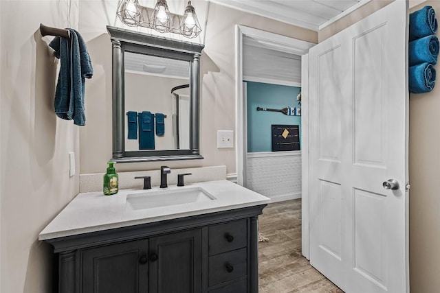 bathroom with hardwood / wood-style flooring, vanity, and a chandelier