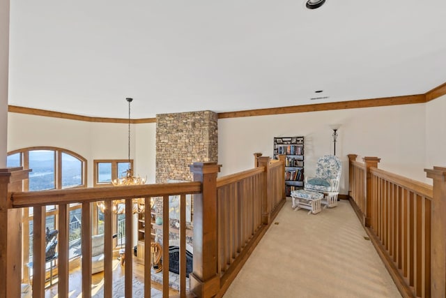 hallway featuring light carpet, visible vents, a chandelier, and an upstairs landing