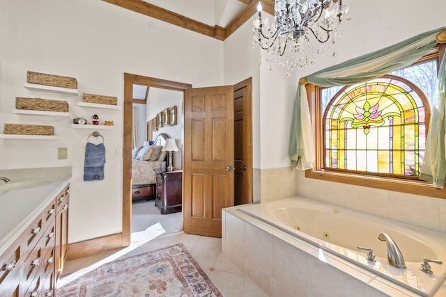 bathroom with tile patterned flooring, a tub with jets, a chandelier, and vanity