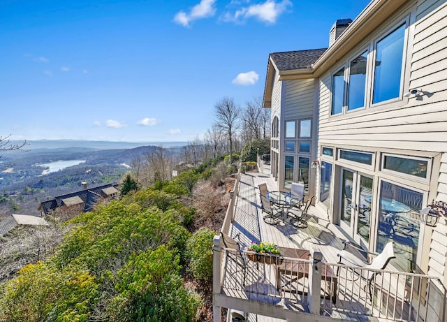 balcony with outdoor dining area and a mountain view