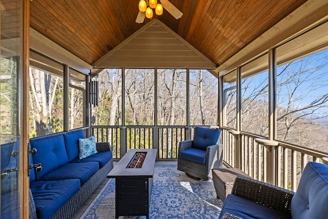 sunroom with wood ceiling, vaulted ceiling, and a ceiling fan