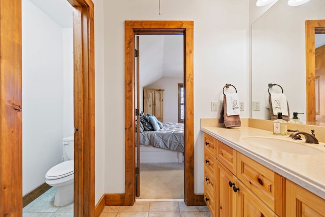 ensuite bathroom featuring toilet, ensuite bath, tile patterned floors, vaulted ceiling, and vanity