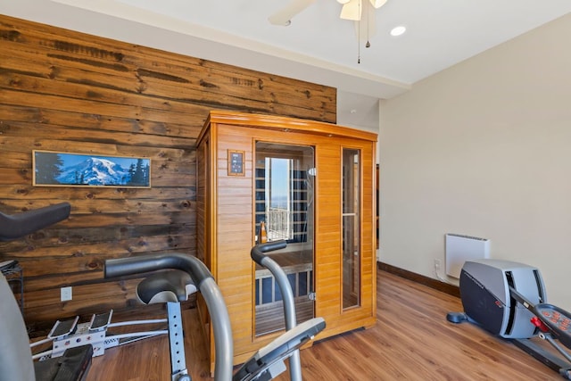 exercise room featuring ceiling fan, baseboards, and wood finished floors