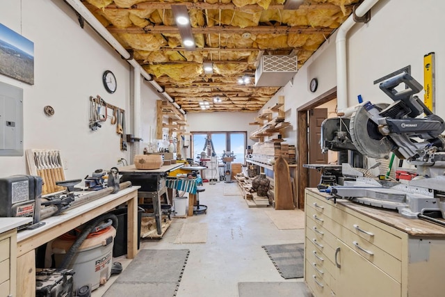 misc room with a workshop area and unfinished concrete flooring