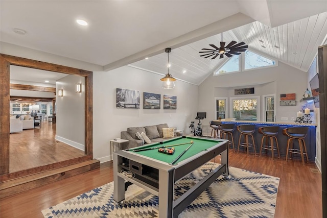 game room featuring pool table, a ceiling fan, wood finished floors, bar area, and beamed ceiling