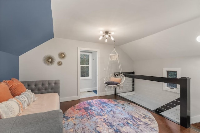 sitting room featuring vaulted ceiling, wood finished floors, and baseboards