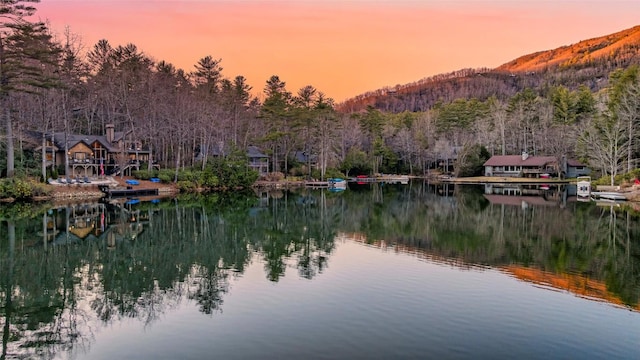 view of water feature featuring a wooded view and a mountain view