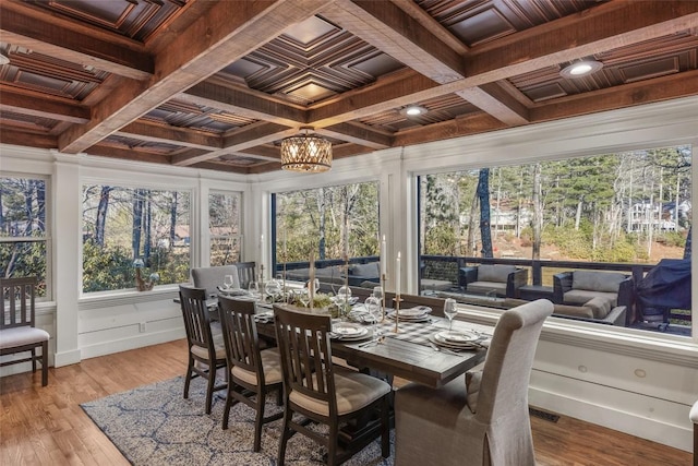 sunroom / solarium with an inviting chandelier, coffered ceiling, and beam ceiling