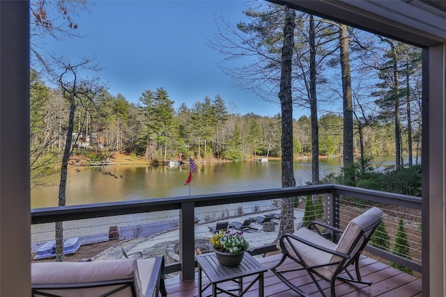 wooden terrace featuring a water view