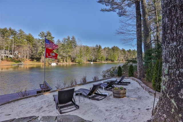 exterior space featuring a water view and a forest view