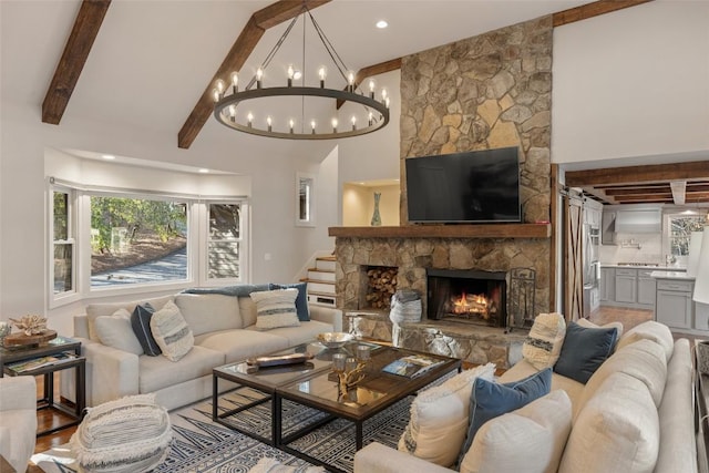 living room with stairway, beam ceiling, a stone fireplace, and a high ceiling