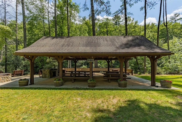 view of property's community featuring a lawn, a gazebo, and a patio