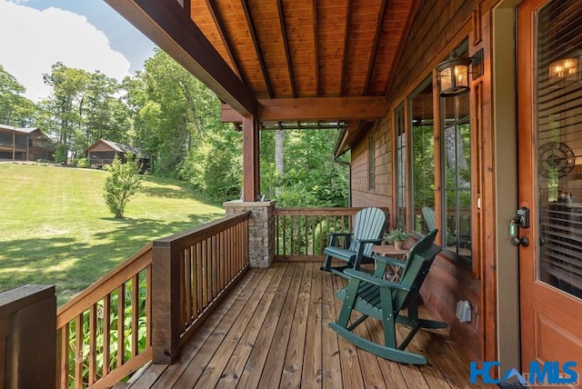 wooden terrace with a yard