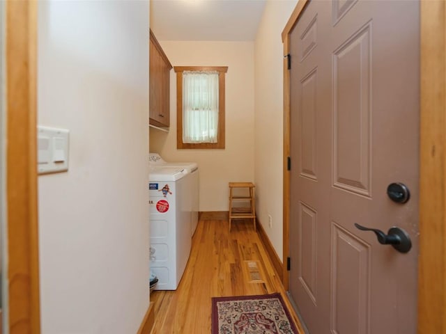 219 Hiwassee Rd, Lake Toxaway, NC 28747 - laundry room with light wood finished floors, cabinet space, and washer and clothes dryer