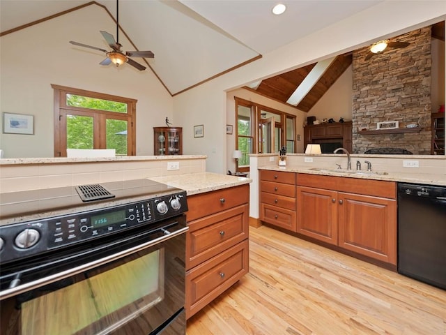 219 Hiwassee Rd, Lake Toxaway, NC 28747 - kitchen featuring black appliances, ceiling fan, light wood-style floors, light stone countertops, and brown cabinetry