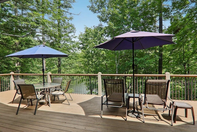 219 Hiwassee Rd, Lake Toxaway, NC 28747 - kitchen with black appliances, tasteful backsplash, brown cabinetry, light wood-style flooring, and light stone countertops