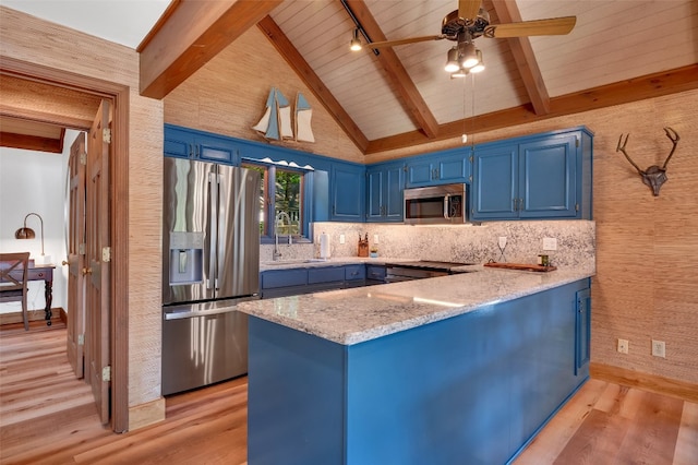 35 Toxaway Landing Dr, Lake Toxaway, NC 28747 - kitchen with appliances with stainless steel finishes, blue cabinetry, a peninsula, light wood-style floors, and backsplash