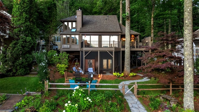 35 Toxaway Landing Dr, Lake Toxaway, NC 28747 - back of house with a chimney, a wooden deck, a shingled roof, and a wooded view