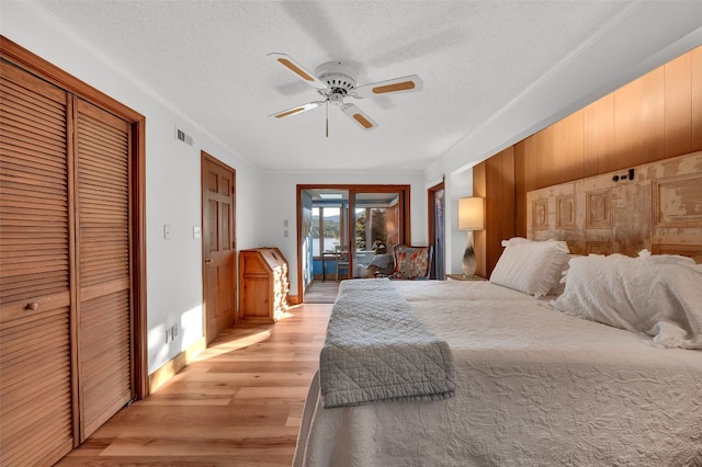 35 Toxaway Landing Dr, Lake Toxaway, NC 28747 - bedroom with access to exterior, light wood finished floors, a ceiling fan, and a textured ceiling