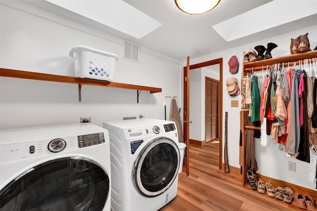 35 Toxaway Landing Dr, Lake Toxaway, NC 28747 - laundry room featuring washer and dryer, a skylight, and light wood-type flooring