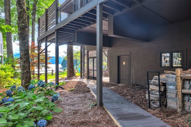 35 Toxaway Landing Dr, Lake Toxaway, NC 28747 - view of exterior entry with stucco siding and a balcony